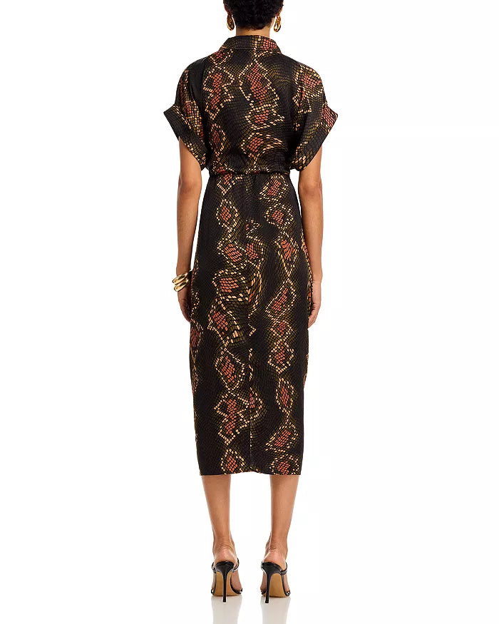 Woman wearing a black patterned dress on a white background