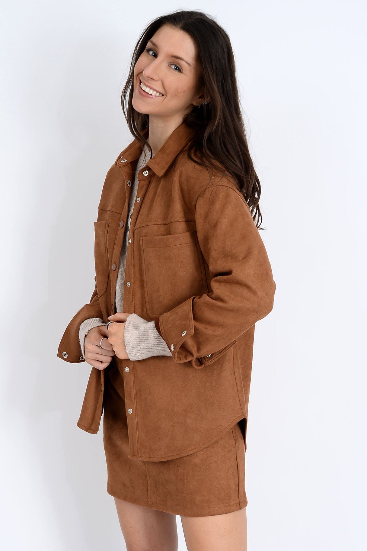 Woman wearing a brown jacket on a white background