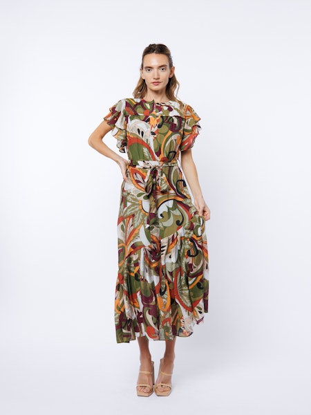 Woman wearing a patterned dress on a white background