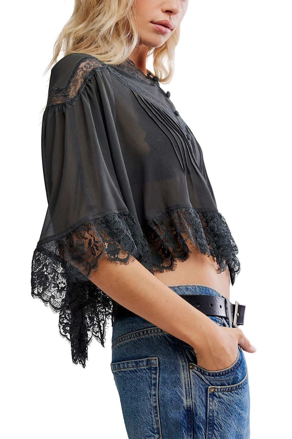 Black lace top worn by a person on a white background