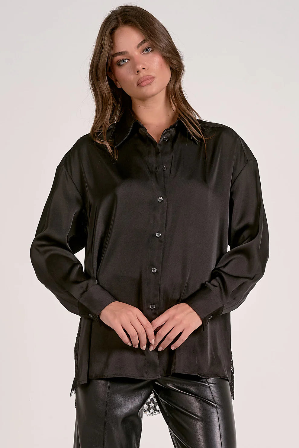 Woman wearing a black shirt and black pants on a white background