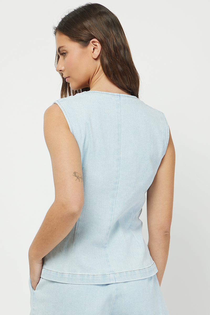 Back view showing denim vest fit and stitching detail