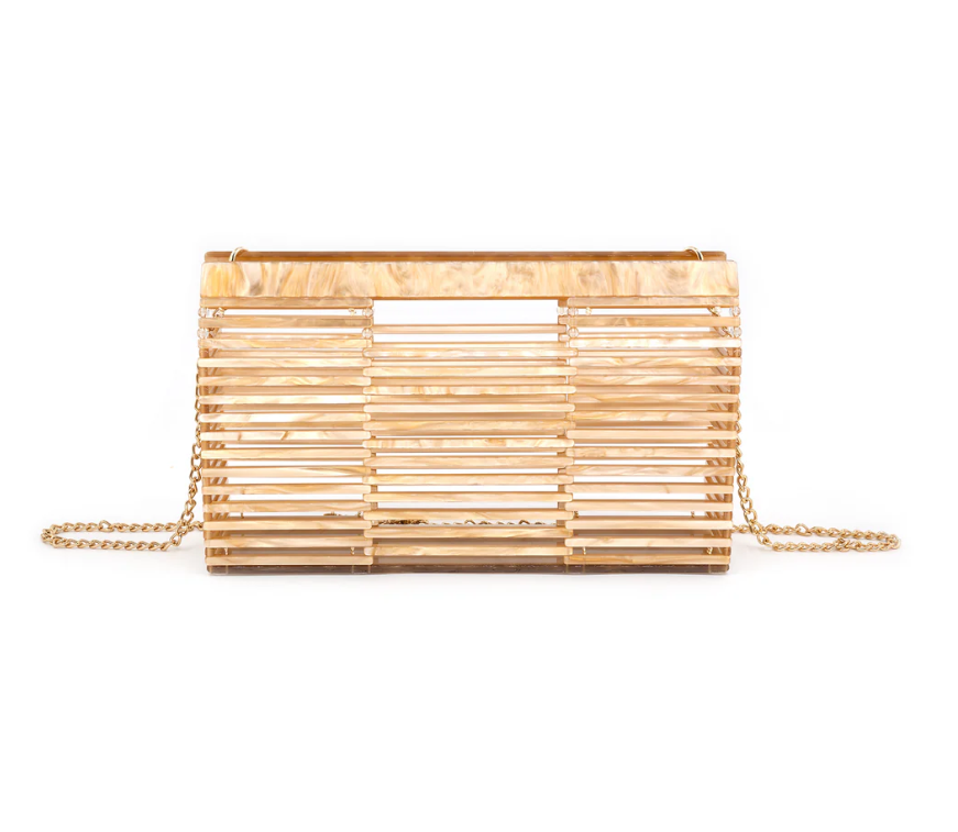 An acrylic clutch with a bamboo-like pattern and a gold chain strap.