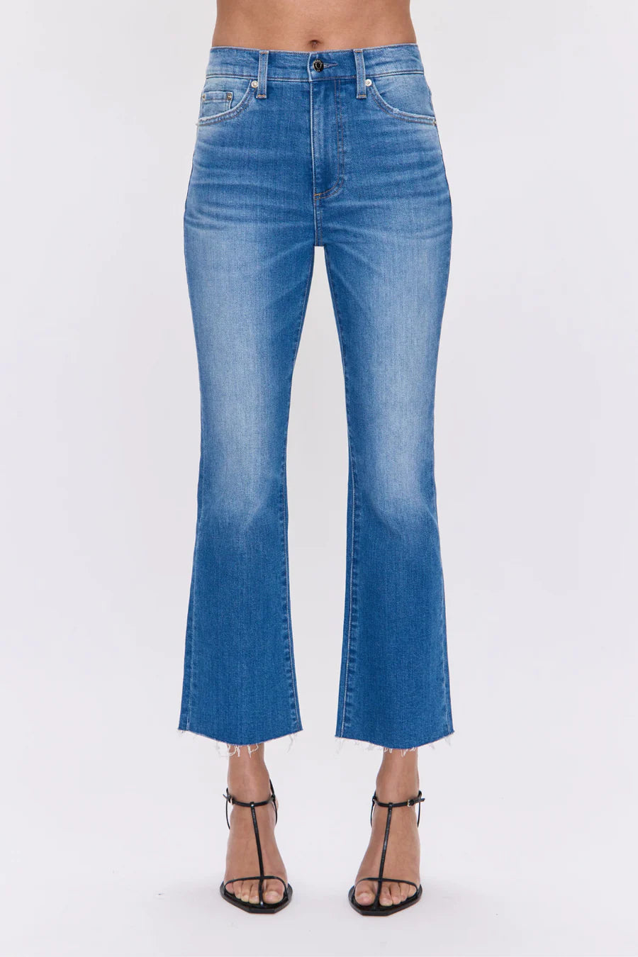 Blue jeans worn by a person on a white background