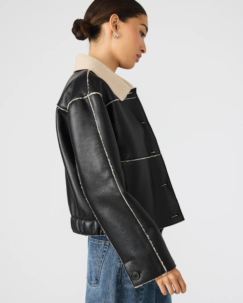 Black leather jacket with beige interior on a plain background