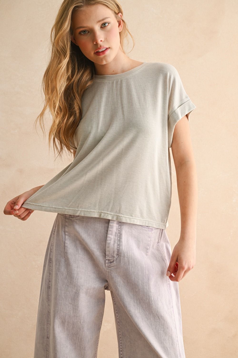 Woman wearing a light gray t-shirt and pants