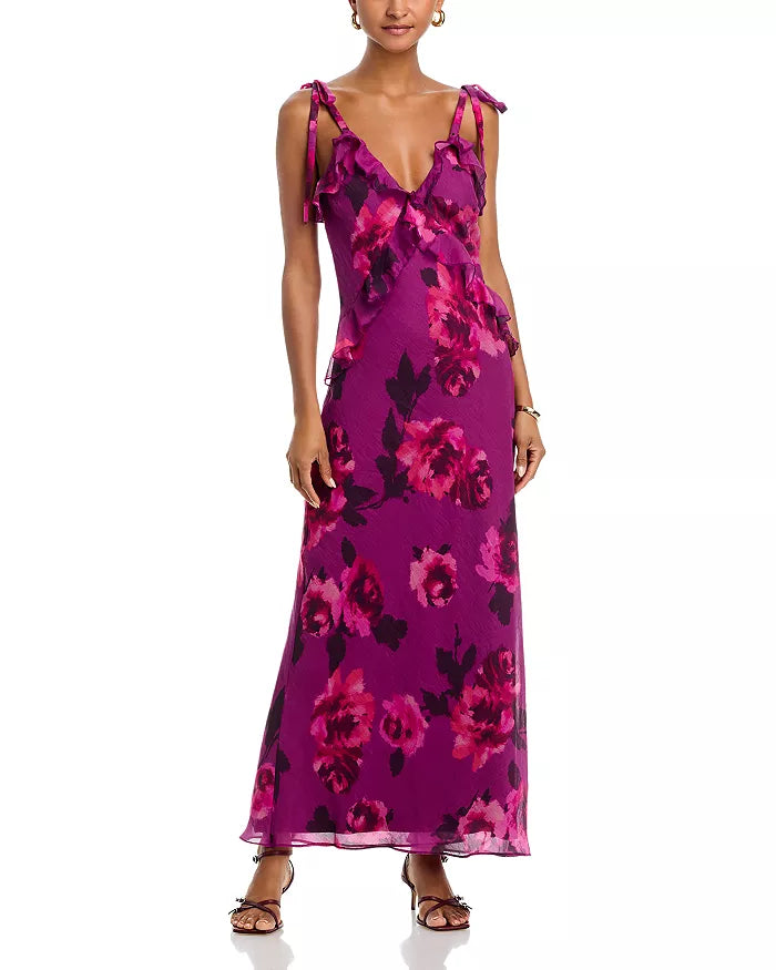 Woman wearing a purple floral dress on a white background