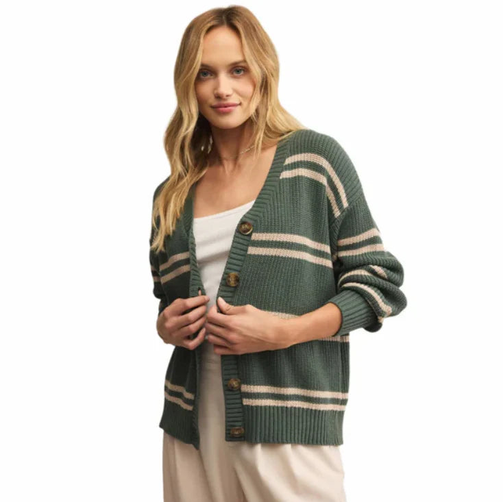 Woman wearing a green and beige striped cardigan on a white background