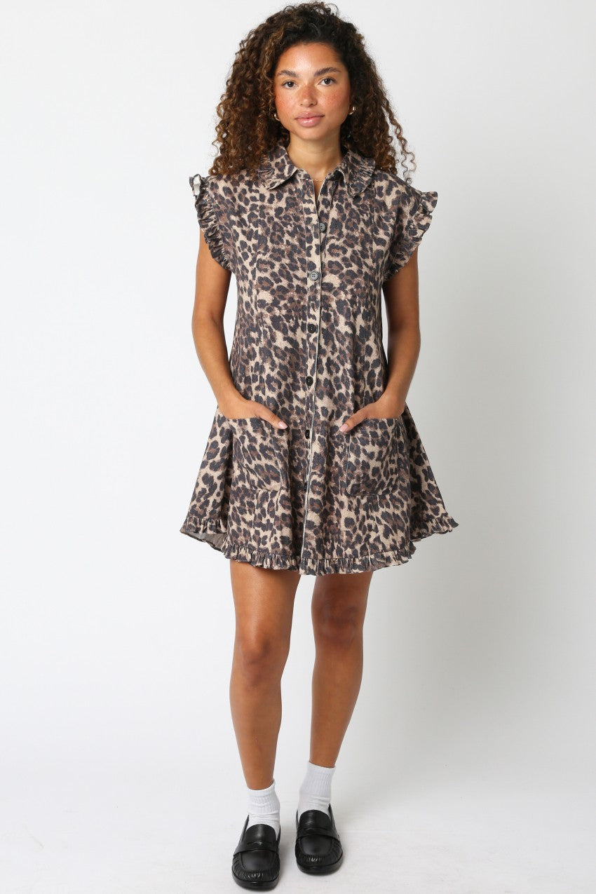 Woman wearing a leopard print dress on a white background