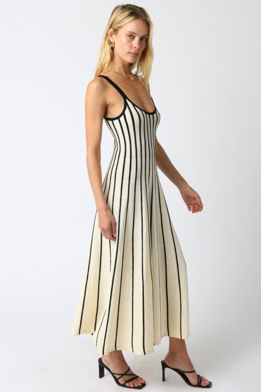 Woman wearing a black and white striped dress on a white background