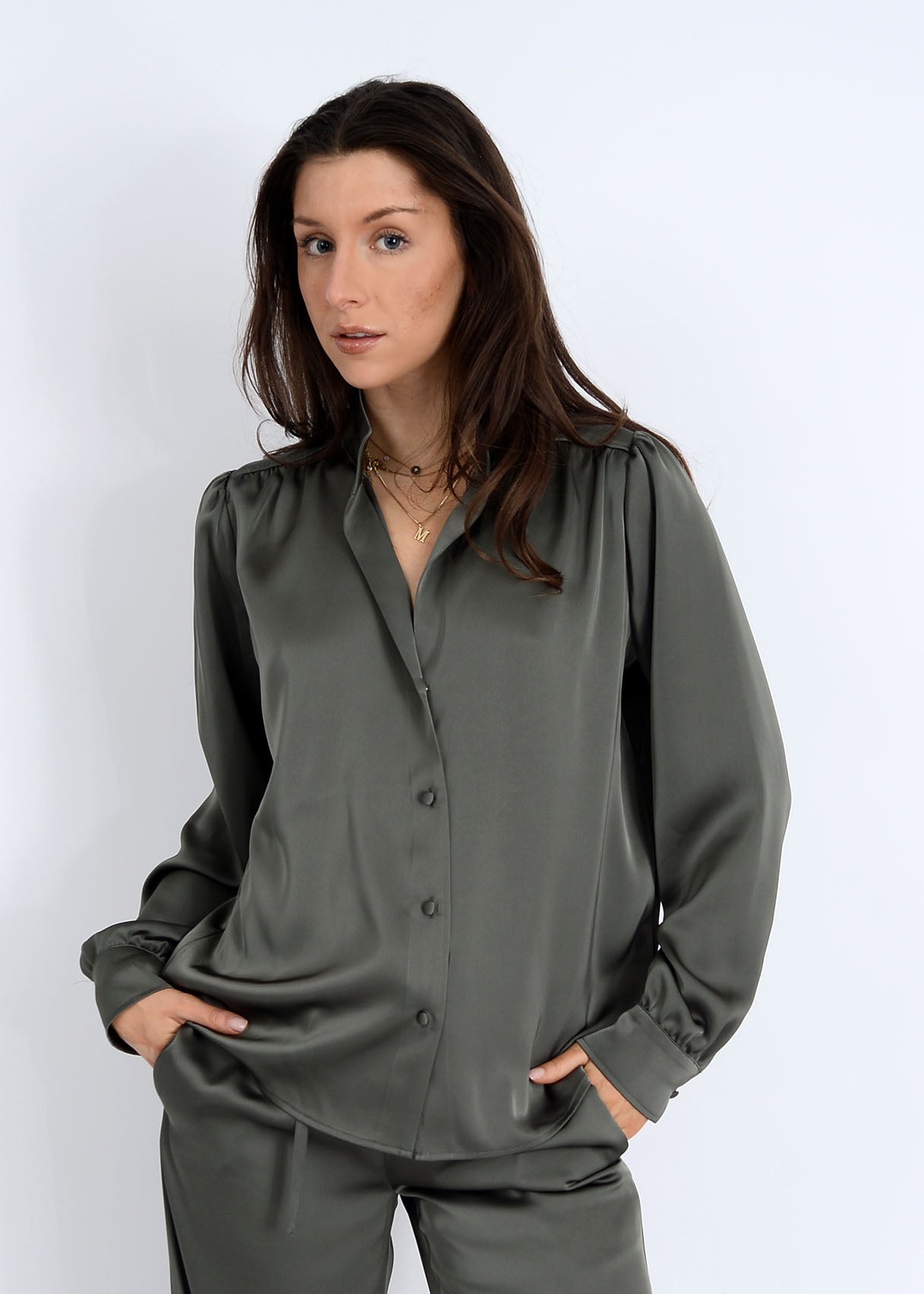 Woman wearing a green blouse against a white background