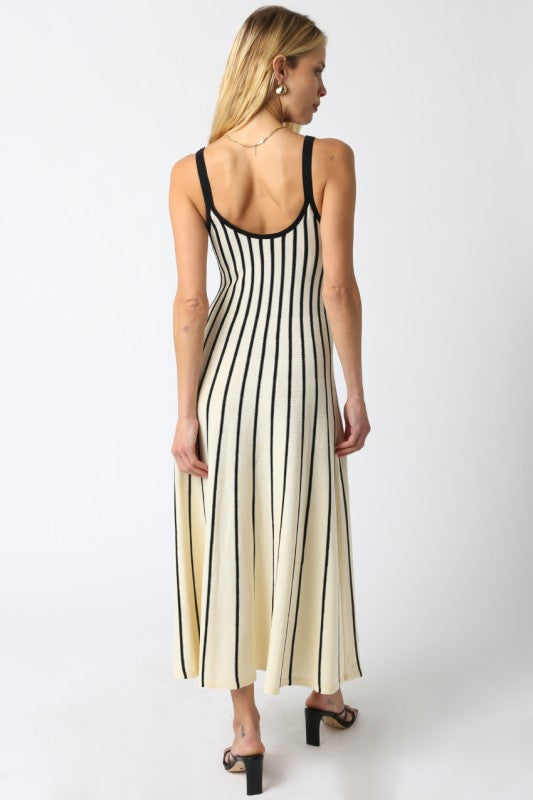 Woman wearing a black and white striped dress on a white background