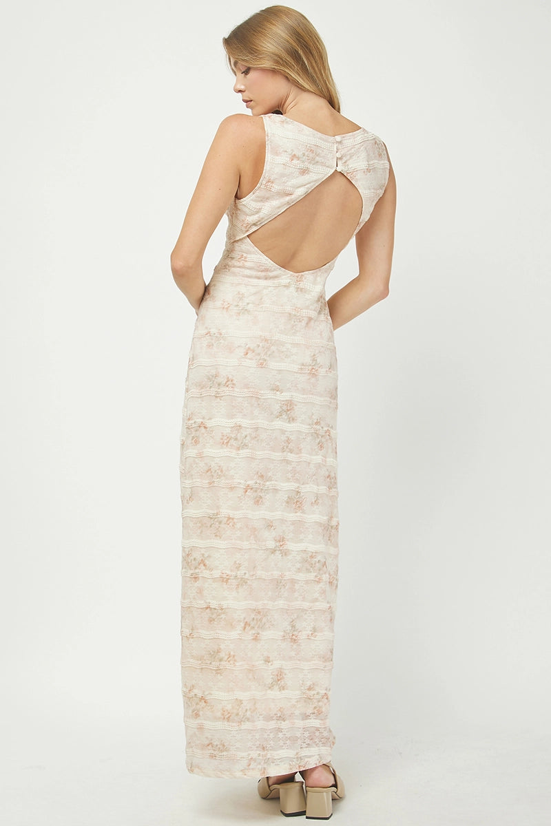 Woman wearing a long, light-colored dress with an open back on a white background