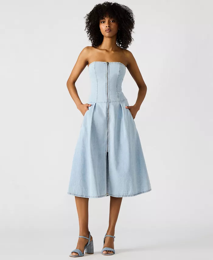 Woman wearing a light blue strapless dress on a white background