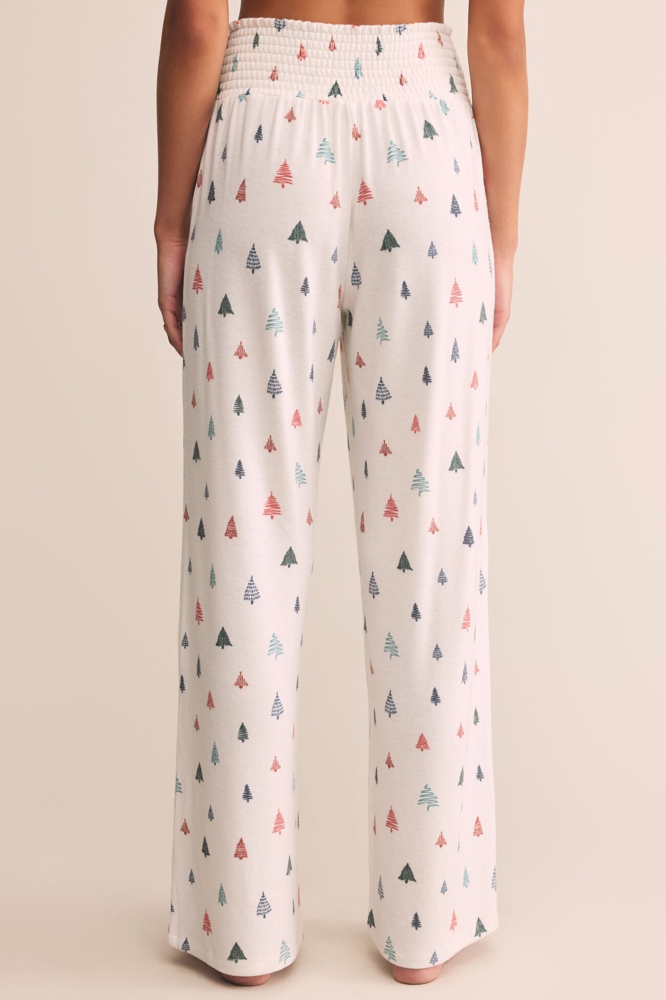Wide-leg pants with a pattern of small trees on a plain background