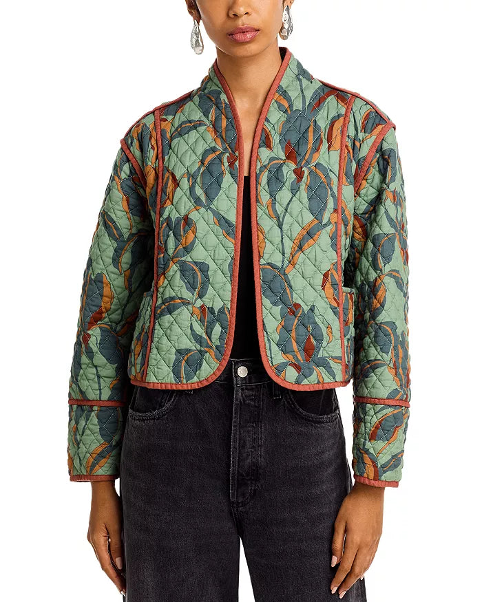 Woman wearing a patterned quilted jacket on a white background