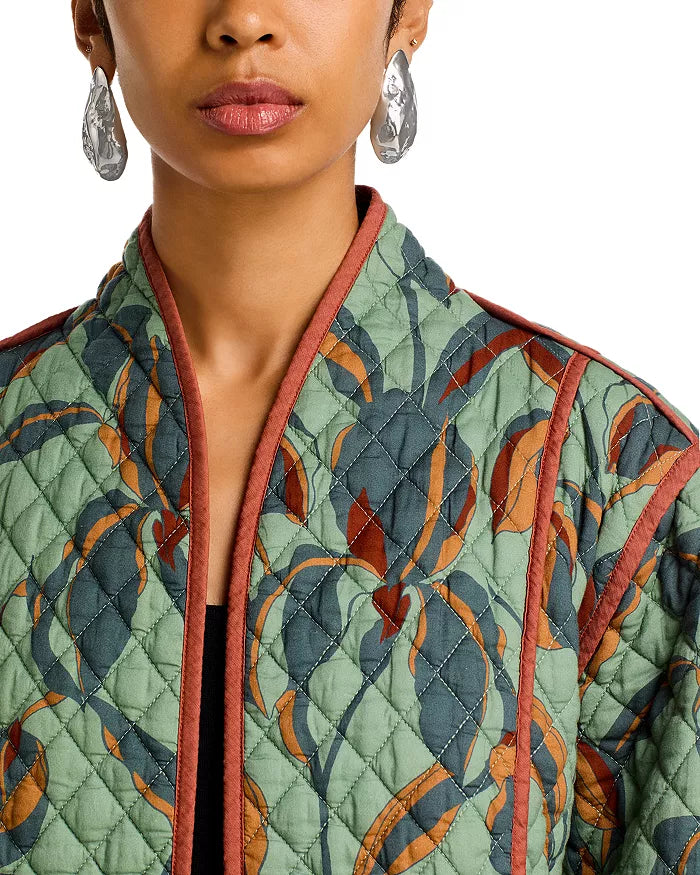 Close-up of a person wearing a patterned jacket with a neutral background