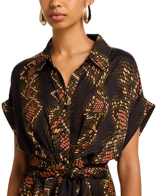 Woman wearing a patterned black dress with a white background