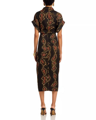 Woman wearing a black patterned dress on a white background