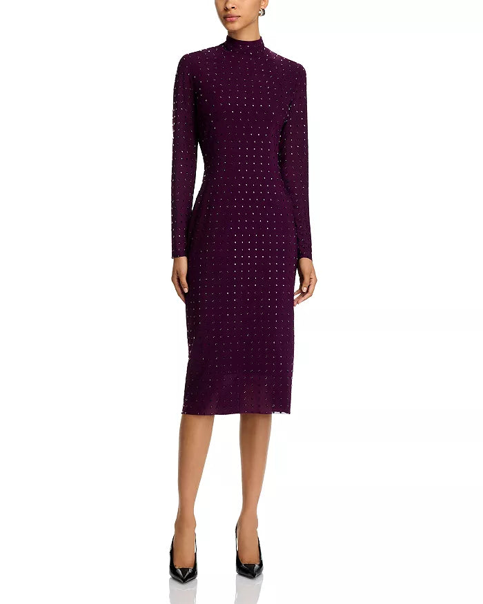 Woman wearing a purple dress with a pattern on a white background