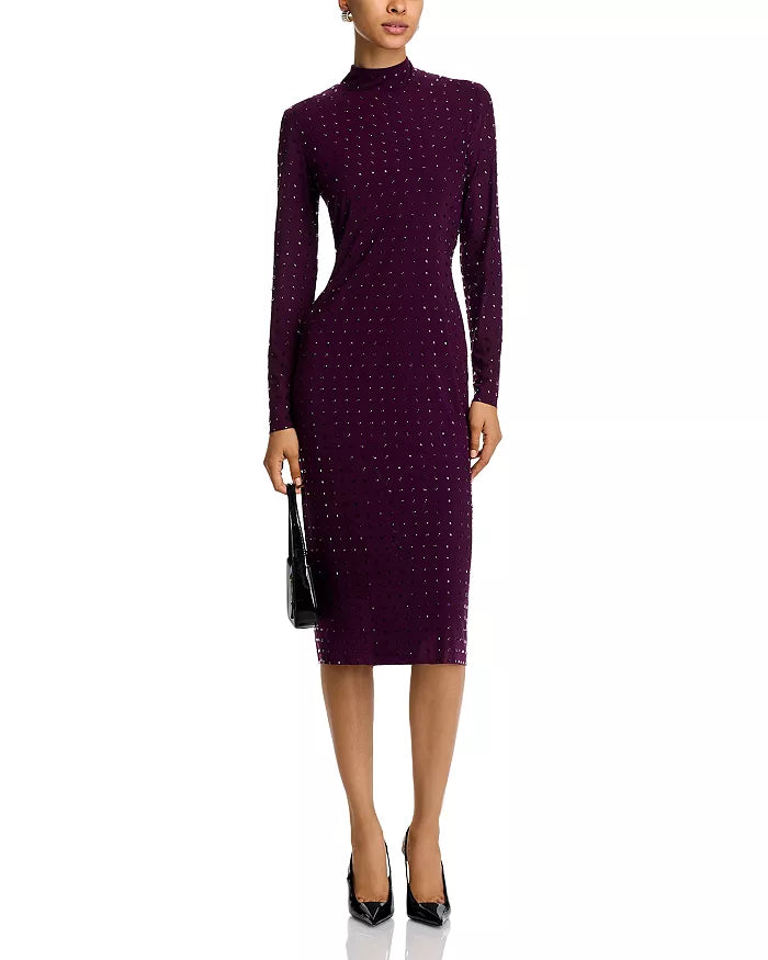 Woman wearing a purple dress with a pattern on a white background