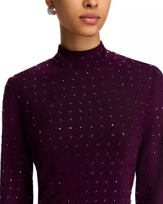 Close-up of a person wearing a dark purple turtleneck sweater with a subtle pattern.