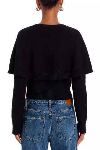 Person wearing a black sweater and blue jeans on a white background