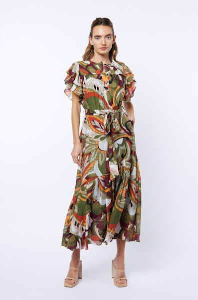 Woman wearing a colorful patterned dress on a white background