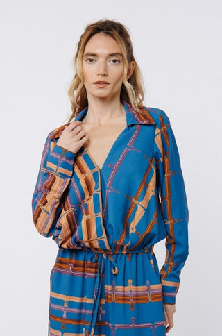 Woman wearing a blue and brown patterned outfit on a white background