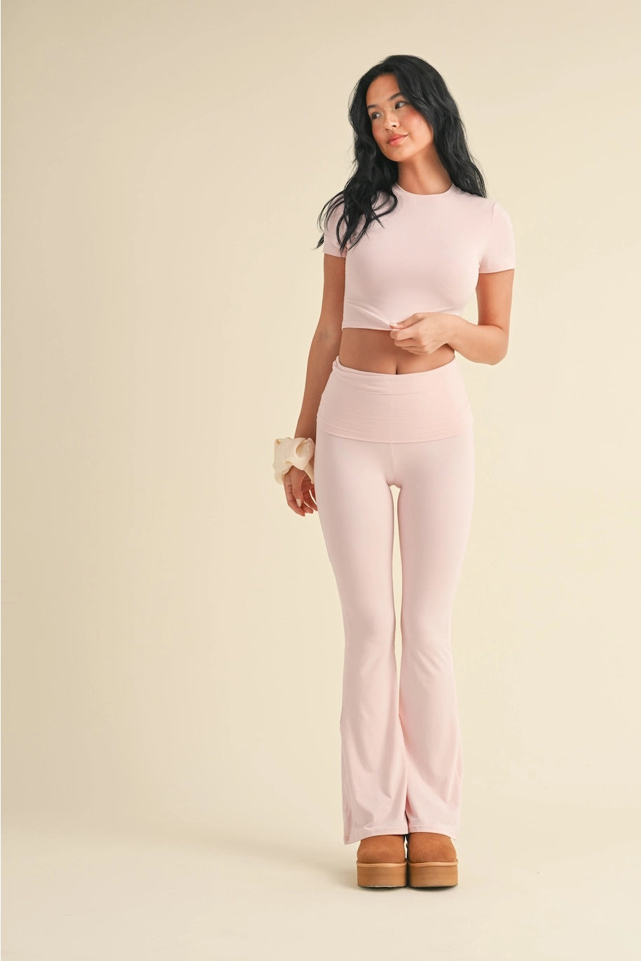 Woman wearing a pink outfit with a beige background