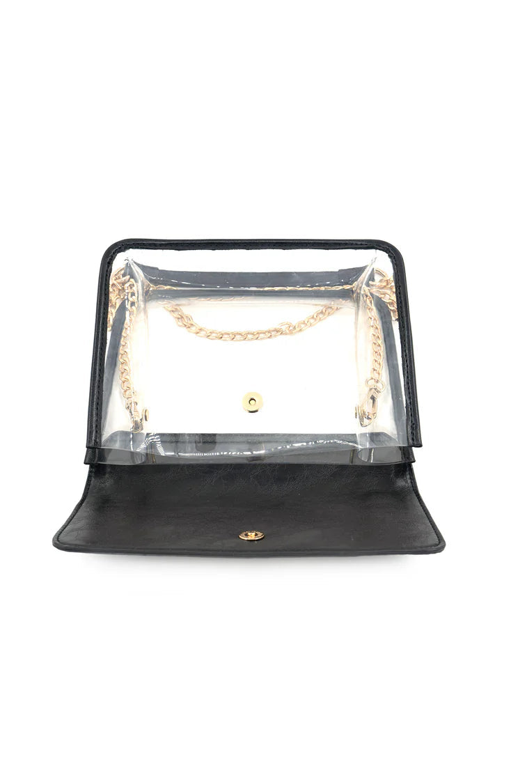Black clear-top handbag with gold chain detail on a white background