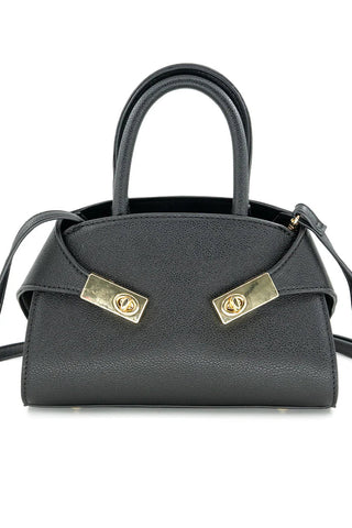 Black handbag with gold accents on a white background