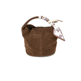 Brown suede handbag with a tag on a white background