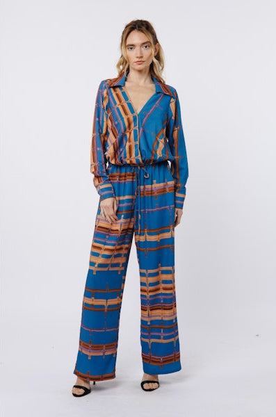 Woman wearing a blue and brown patterned outfit on a white background