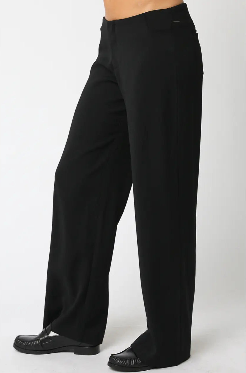 Black pants worn by a person on a white background