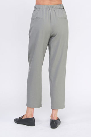 Gray pants worn by a person on a white background