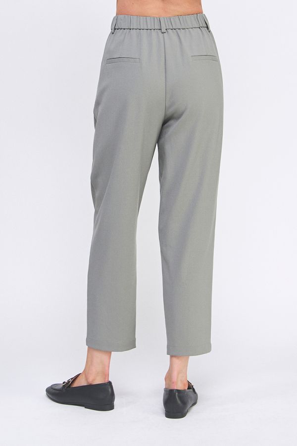 Gray pants worn by a person on a white background