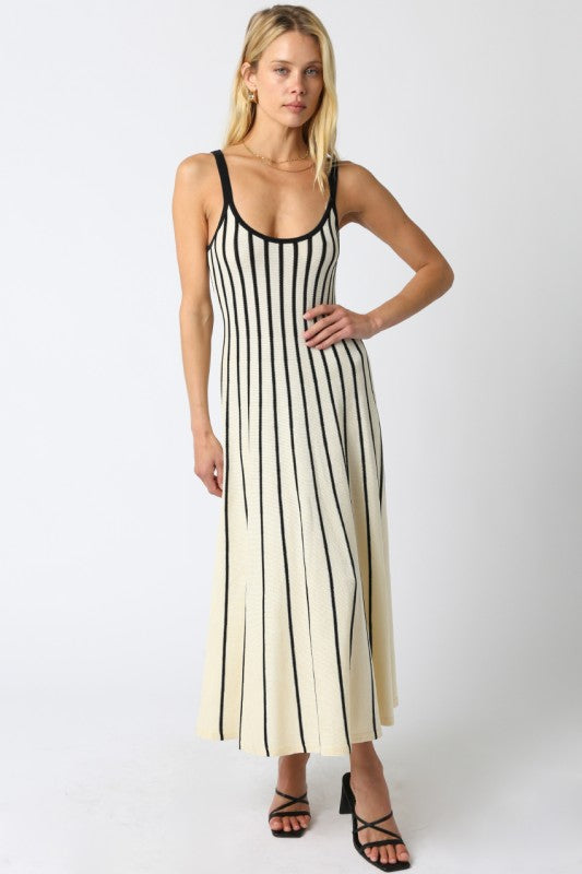 Woman wearing a black and white striped dress on a white background