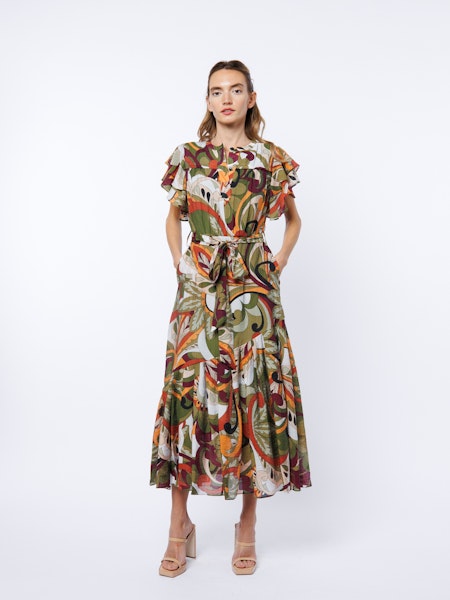 Woman wearing a patterned dress on a white background