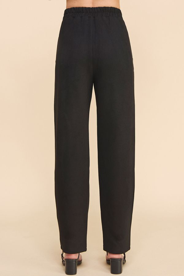 Black pants on a beige background