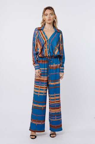 Woman wearing a blue and brown patterned outfit on a white background