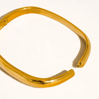Gold bracelet on a white background