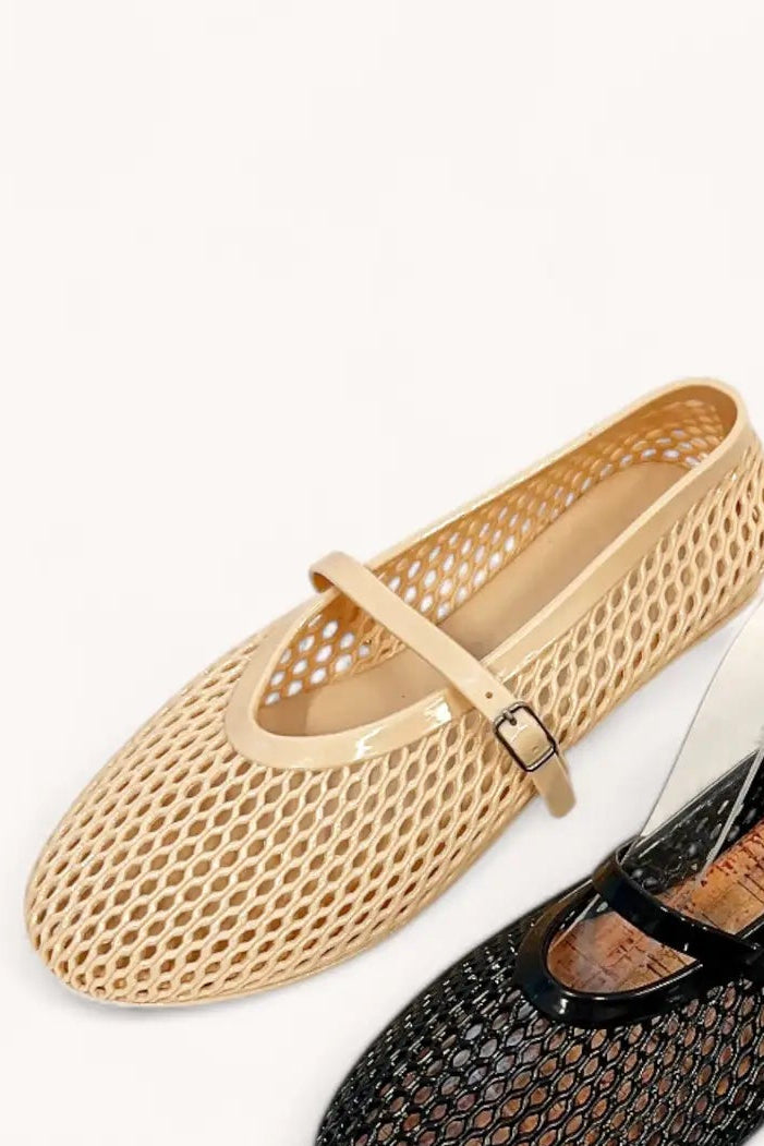 Beige and black mesh shoes on a white background