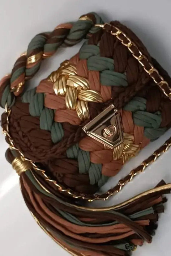 Multicolored braided bag with gold chain and clasp on a white background