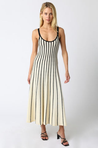 Woman wearing a black and white striped dress on a white background