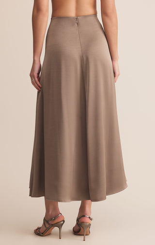 Brown skirt worn by a person on a beige background