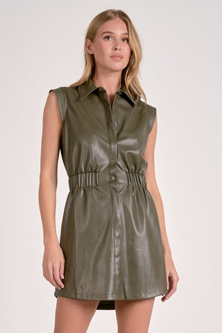 Woman wearing a green leather dress against a white background