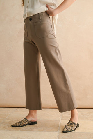 Person wearing beige pants with a neutral background