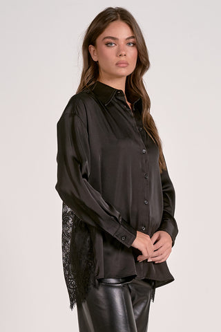 Woman wearing a black blouse with a white background