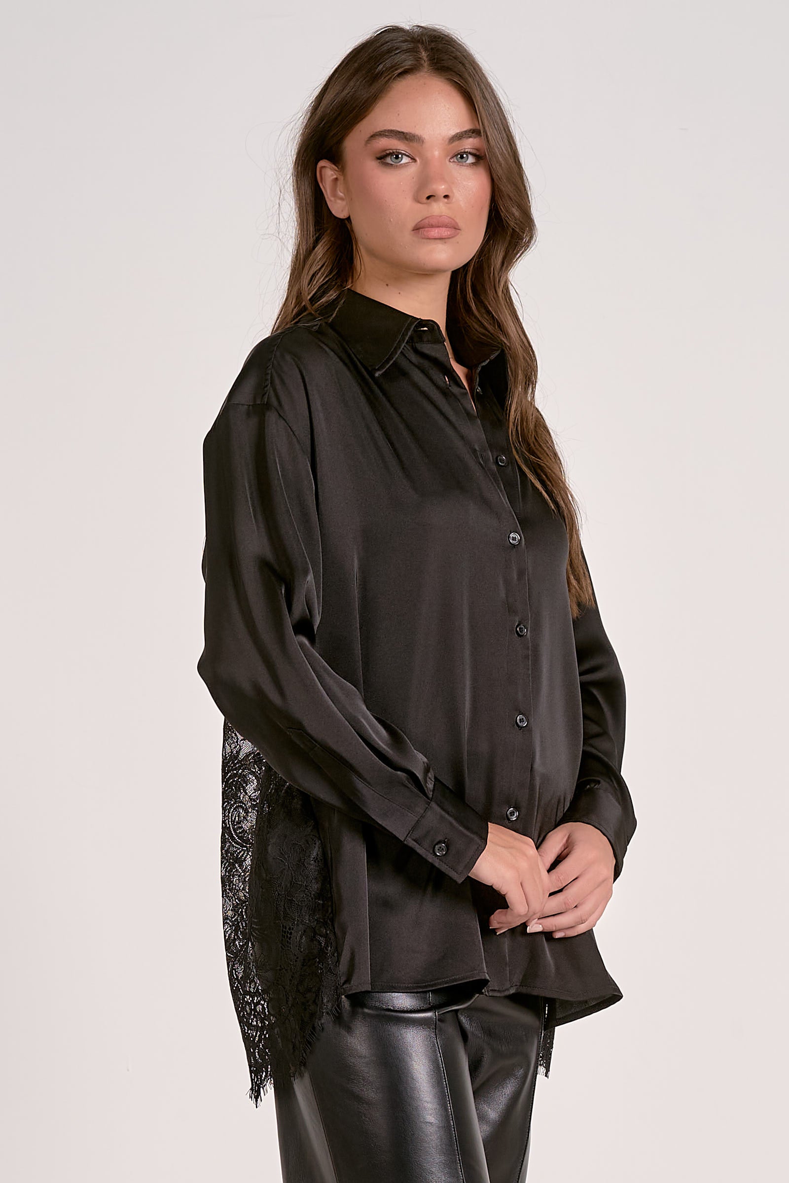 Woman wearing a black blouse with a white background